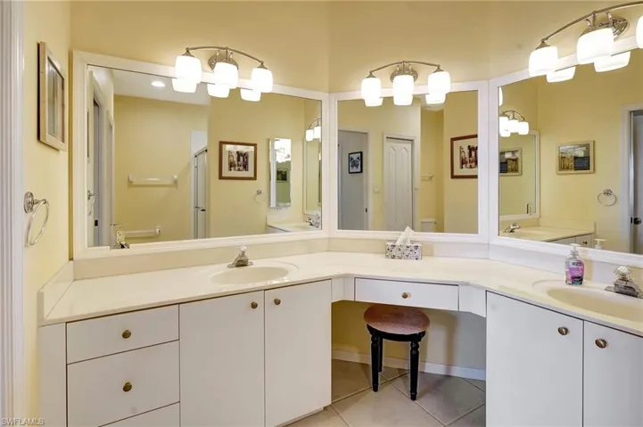 Full bathroom with vanity and tile patterned floors