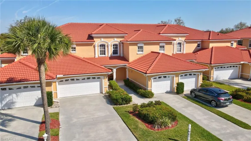 Mediterranean / spanish-style house with an attached garage, driveway, a tile roof, and stucco siding