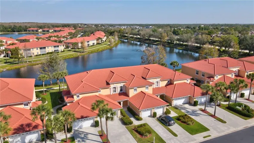 Aerial view featuring a water view and a residential view