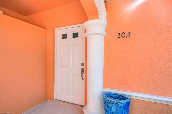 Entrance to property with stucco siding