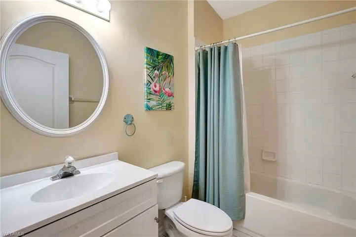 Full bathroom featuring vanity, shower / bath combination with curtain, and toilet