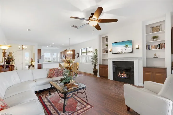 Bedroom with a raised ceiling, ceiling fan, and ornamental molding