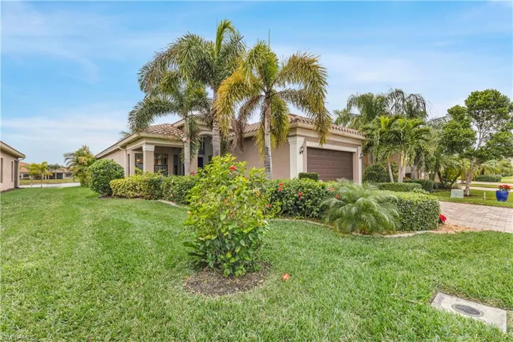 View of front of house with a garage and a front yard