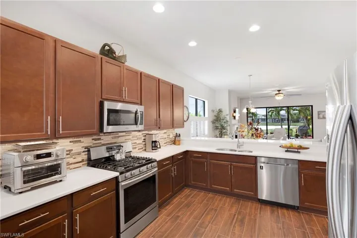 Dining space featuring a wealth of natural light, dark hardwood / wood-style flooring, and an inviting chandelier
