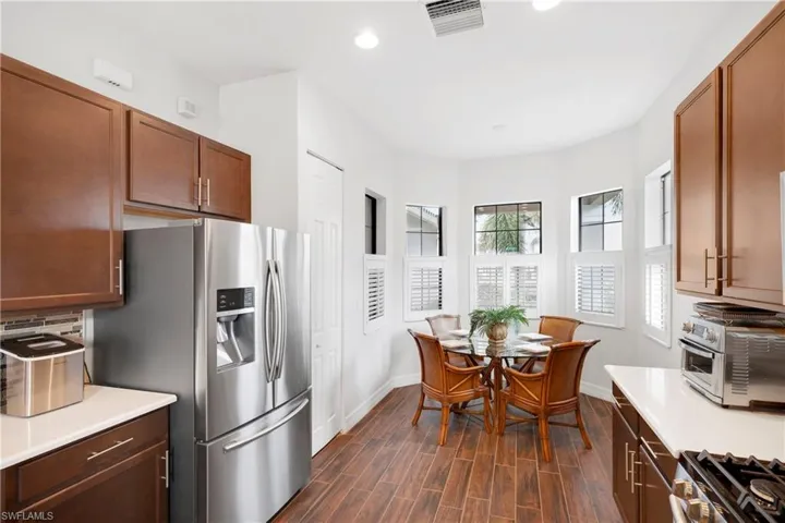 kitchen peninsula, appliances with stainless steel finishes, and sink