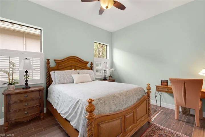 Bedroom with a closet and dark hardwood / wood-style floors