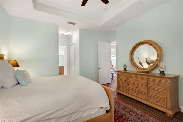 Bedroom with a tray ceiling and crown molding