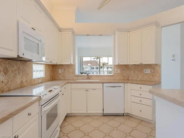 Oversized white kitchen  and decorative backsplash
