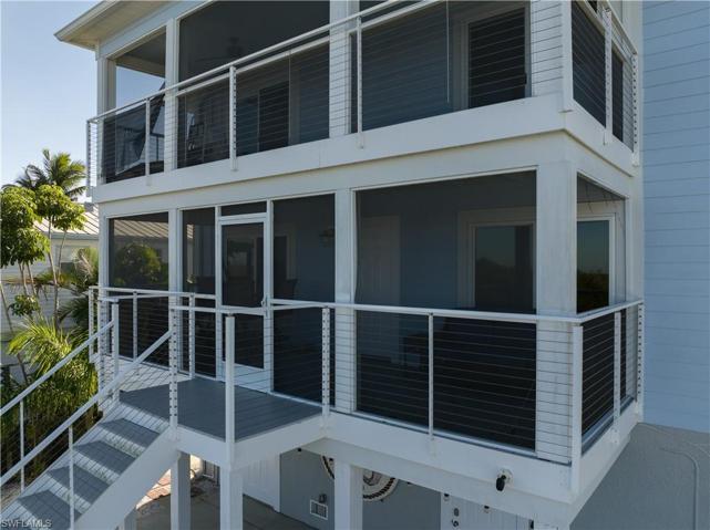Two screened balconies overlook water and pool