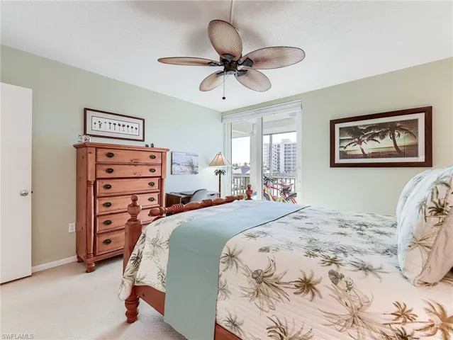 Bedroom with access to outside, carpet floors, a ceiling fan, and a textured ceiling