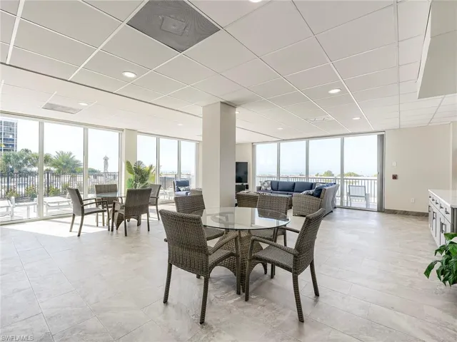 Dining room with expansive windows, a drop ceiling, and recessed lighting