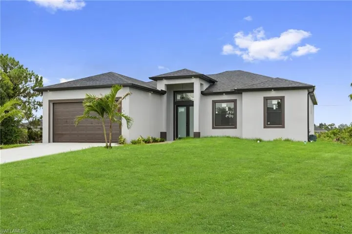 Contemporary-style residence featuring a stucco exterior, dark shingle roof, and an attached two-car garage with a brown panel door