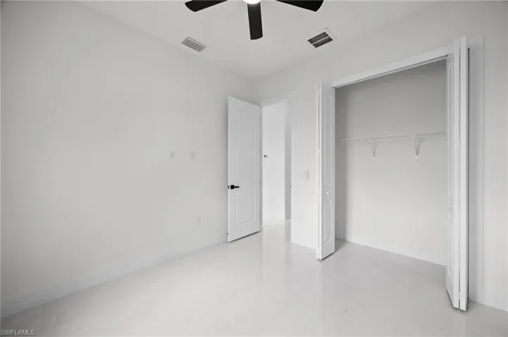 Interior room featuring light-toned flooring and white walls