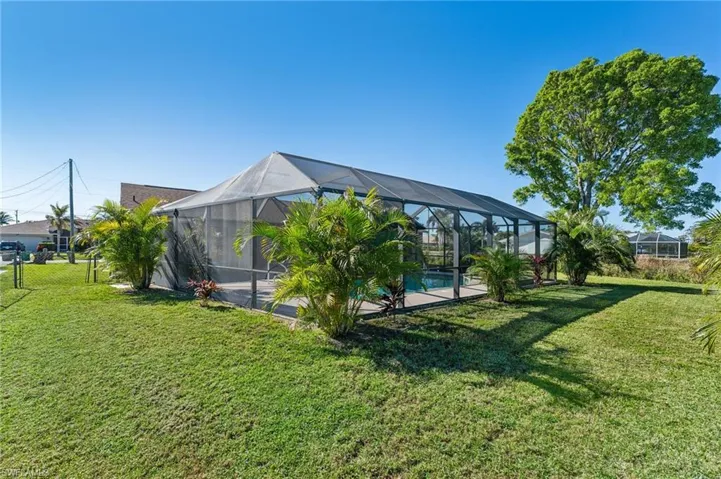 View of green lawn with an outdoor pool