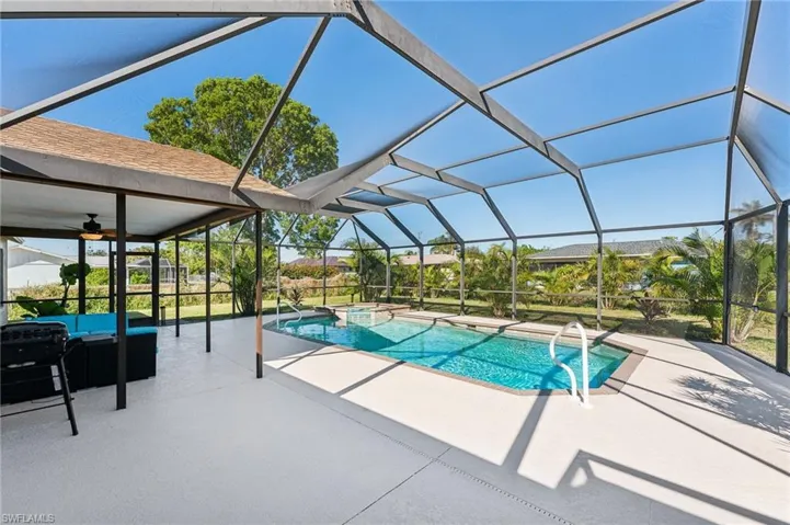 View of swimming pool with a patio, an outdoor living space, ceiling fan, and a lanai