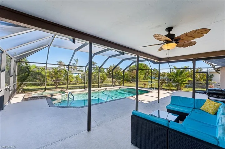 View of pool with a patio area, a lanai, and a pool with connected hot tub