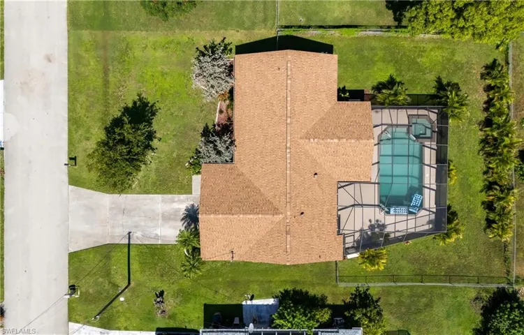 Aerial view of property and surrounding area featuring a pool area