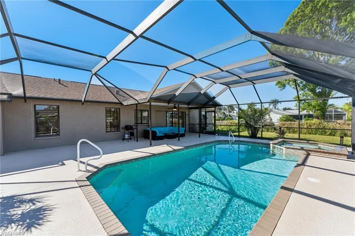 View of pool with a patio, an outdoor living space, a pool with connected hot tub, a lanai, and ceiling fan