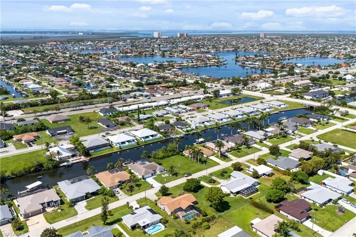 Aerial overview of property's location with a nearby body of water and nearby suburban area