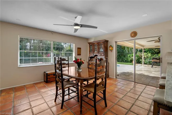 Tiled dining room with ceiling fan