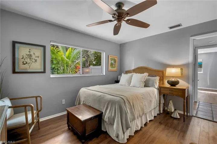 Bedroom featuring ceiling fan and dark hardwood / wood-style flooring
