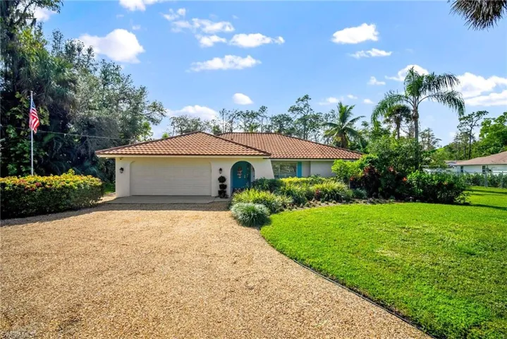 View of front facade with a front yard and a garage