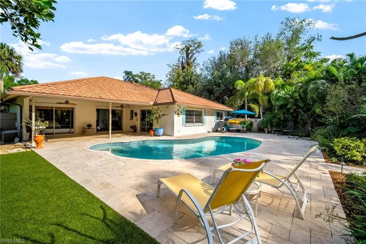 View of swimming pool featuring a patio and ceiling fan