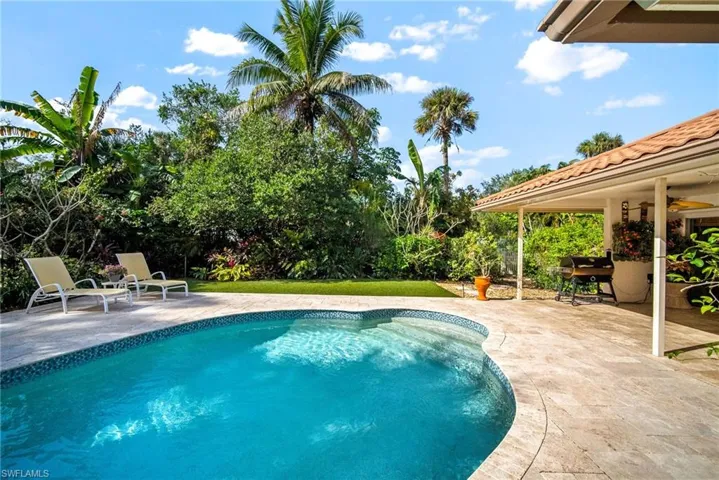 View of pool with ceiling fan and a patio