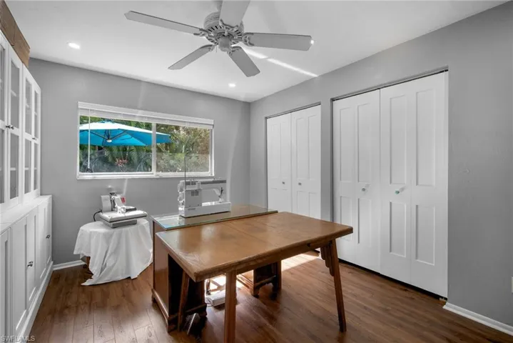Office featuring dark hardwood / wood-style flooring and ceiling fan