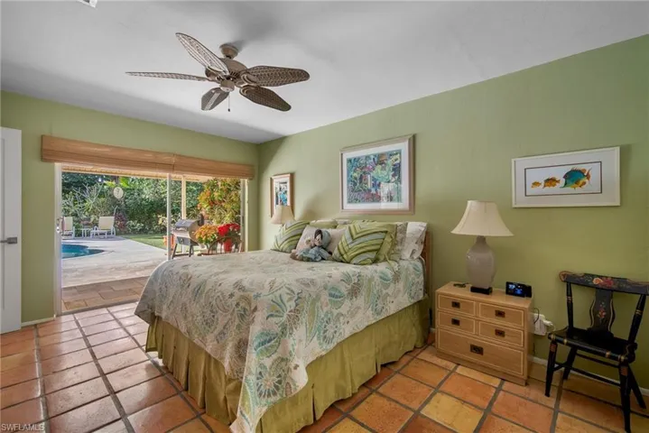 Bedroom with access to exterior, tile patterned flooring, and ceiling fan