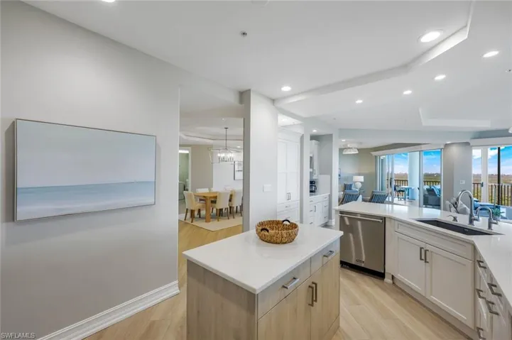 Kitchen with dishwasher, light wood finished floors, open floor plan, and recessed lighting