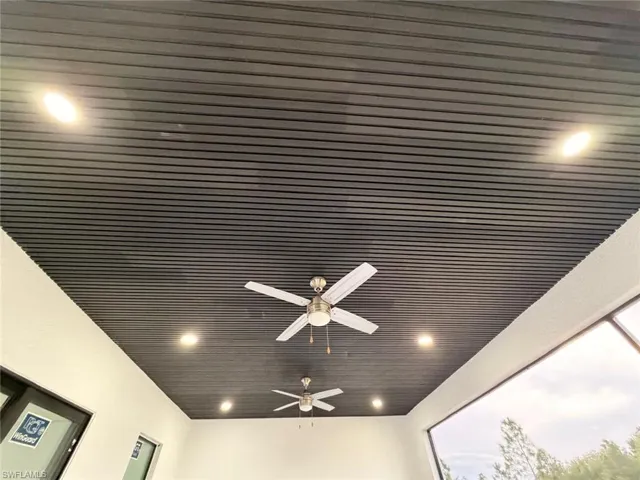 Detailed view of wood ceiling, recessed lighting, and ceiling fan