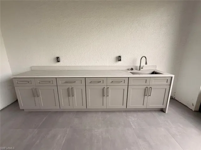 Bathroom featuring vanity and a textured wall