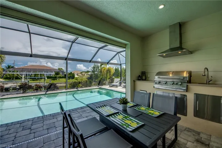 Lanai dining area next to outdoor kitchen
