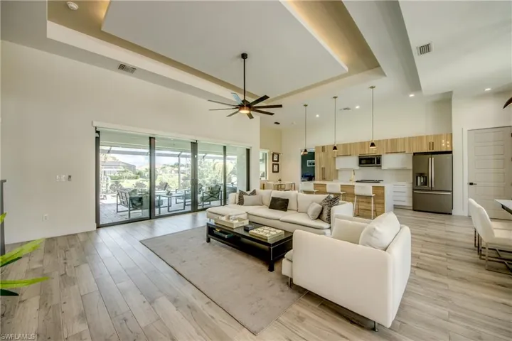 Living Room featuring 9 ft. sliding doors with electric roll down blinds