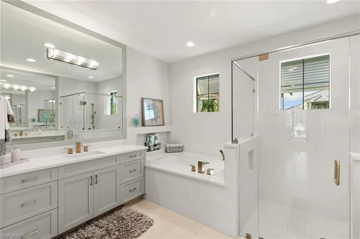 Full bath featuring a stall shower, a garden tub, vanity, recessed lighting, and light tile patterned flooring