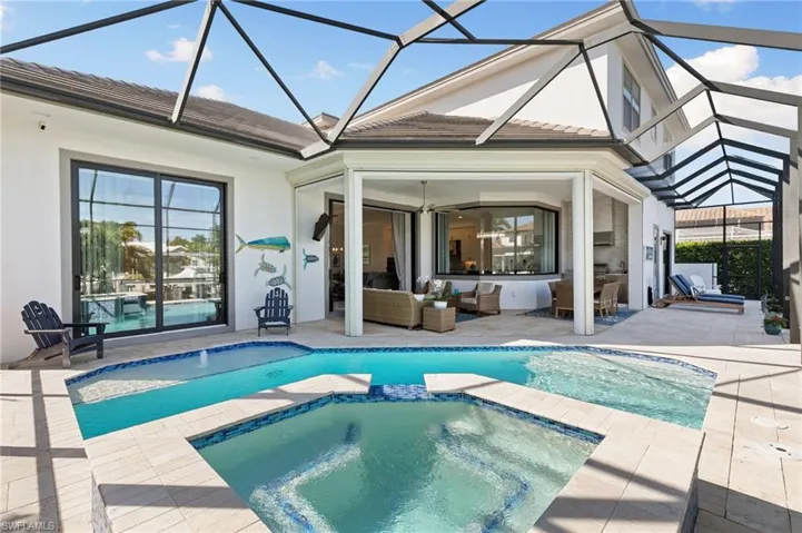 Rear view of house with a sunroom, a patio, stucco siding, and a lanai