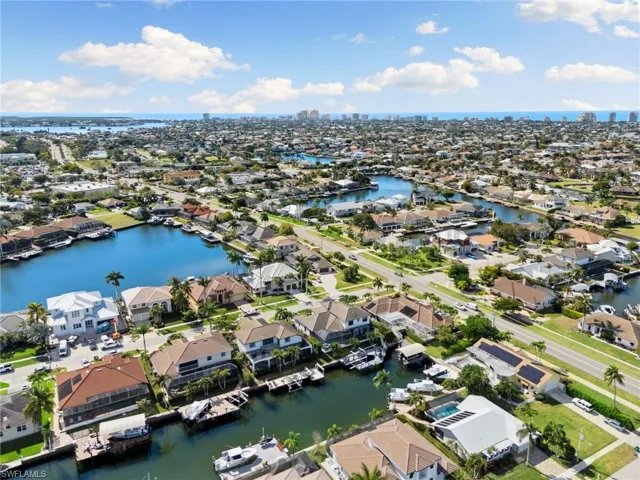 View of property location with a large body of water and nearby suburban area