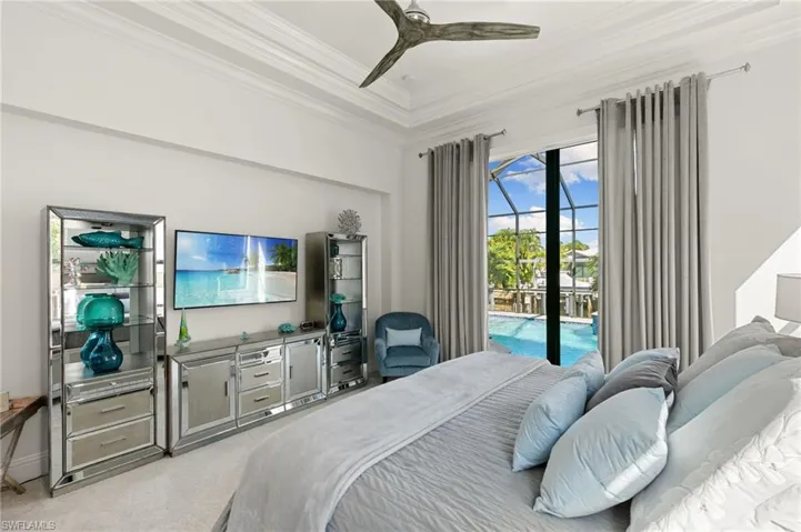 Bedroom featuring access to outside, ceiling fan, ornamental molding, carpet floors, and a sunroom