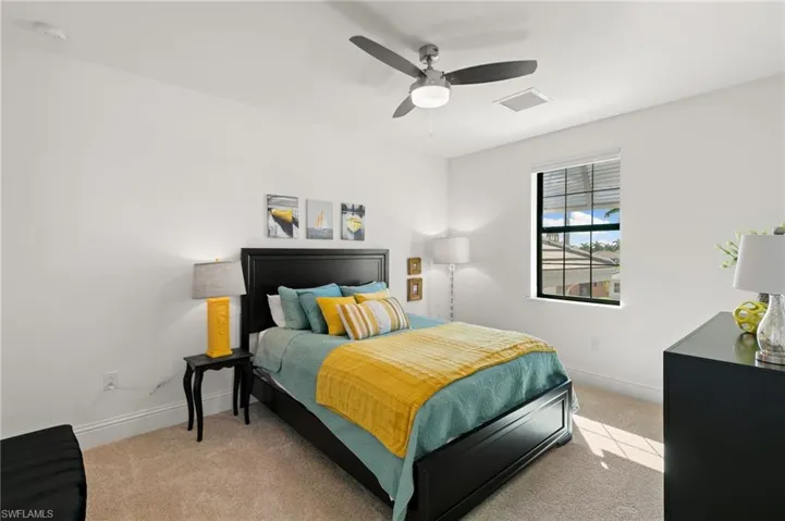 Bedroom with light carpet and ceiling fan