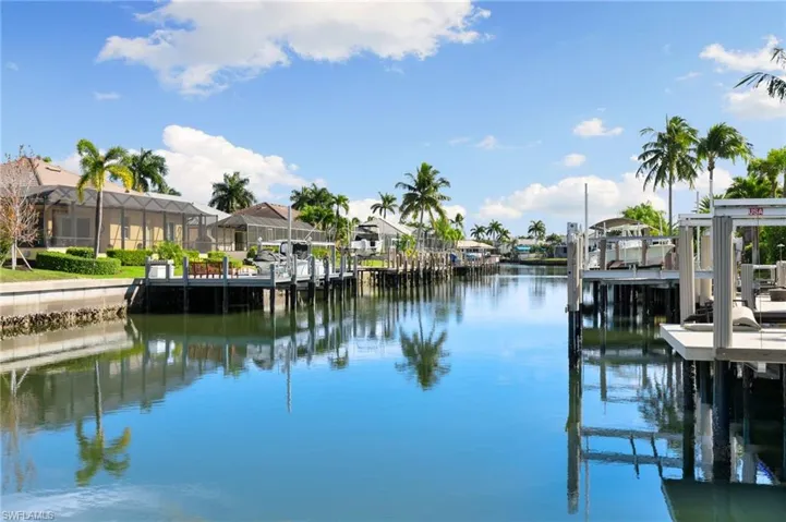 Dock featuring a water view, a residential view, and a sunroom