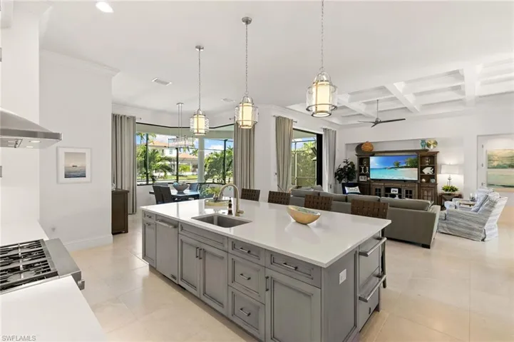Kitchen with hanging light fixtures, a kitchen island with sink, recessed lighting, gray cabinets, and ceiling fan