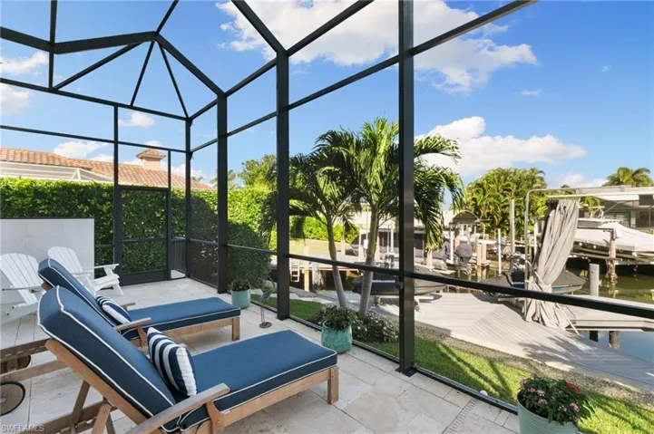 Sunroom / solarium featuring expansive windows and a water view