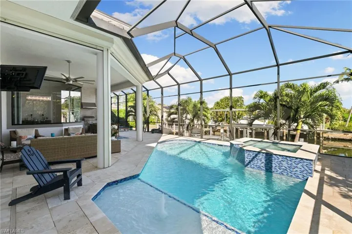 View of pool featuring a patio, an outdoor living space, a sunroom, and a pool with connected hot tub