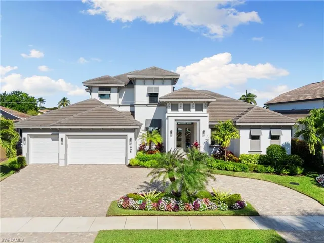 Prairie-style house featuring french doors, a garage, stucco siding, decorative driveway, and a tile roof
