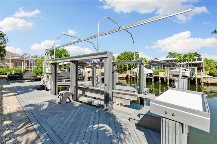 Dock with boat lift and a water view
