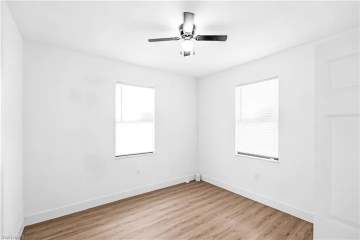 Bright room featuring neutral walls and wood-finish flooring