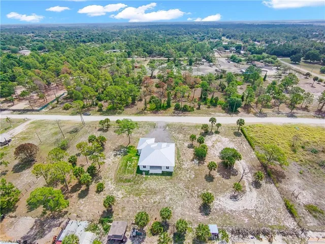 Single-story residence featuring a white exterior and a white metal roof