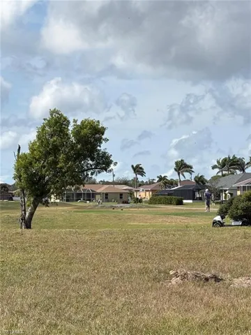 View of yard with a residential view and golf course