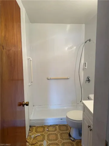 Full bathroom featuring vanity and a shower stall
